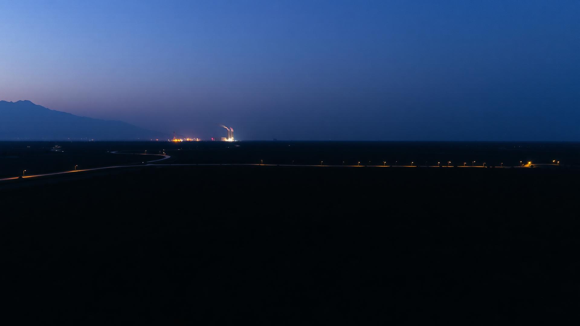 Plantation at dusk with a distant mill